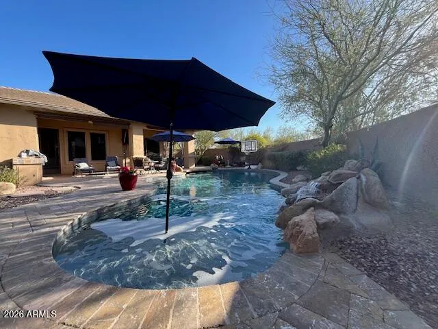 a view of a table and chairs under an umbrella