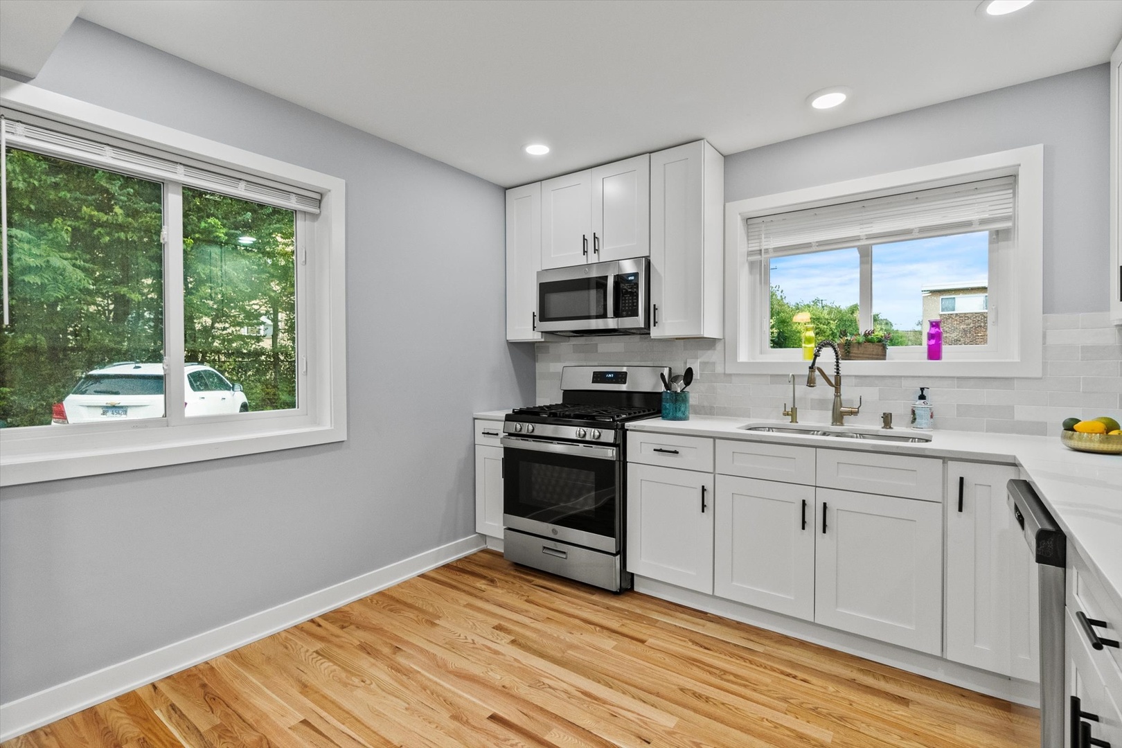 7249 North Campbell Avenue, Unit B Chicago, IL 60645 - Photo 6 of 27 a kitchen with a sink appliances cabinets and a window