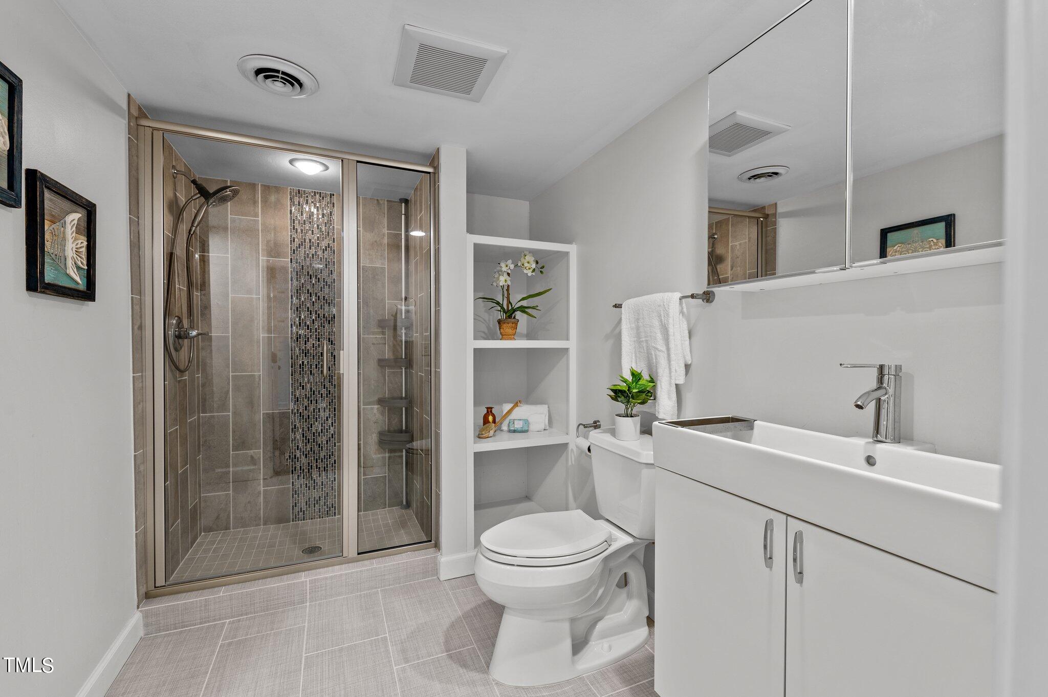 4712 Scollay Court Raleigh, NC 27609 - Photo 16 of 32 Full Bathroom with Double sinks and builts ins