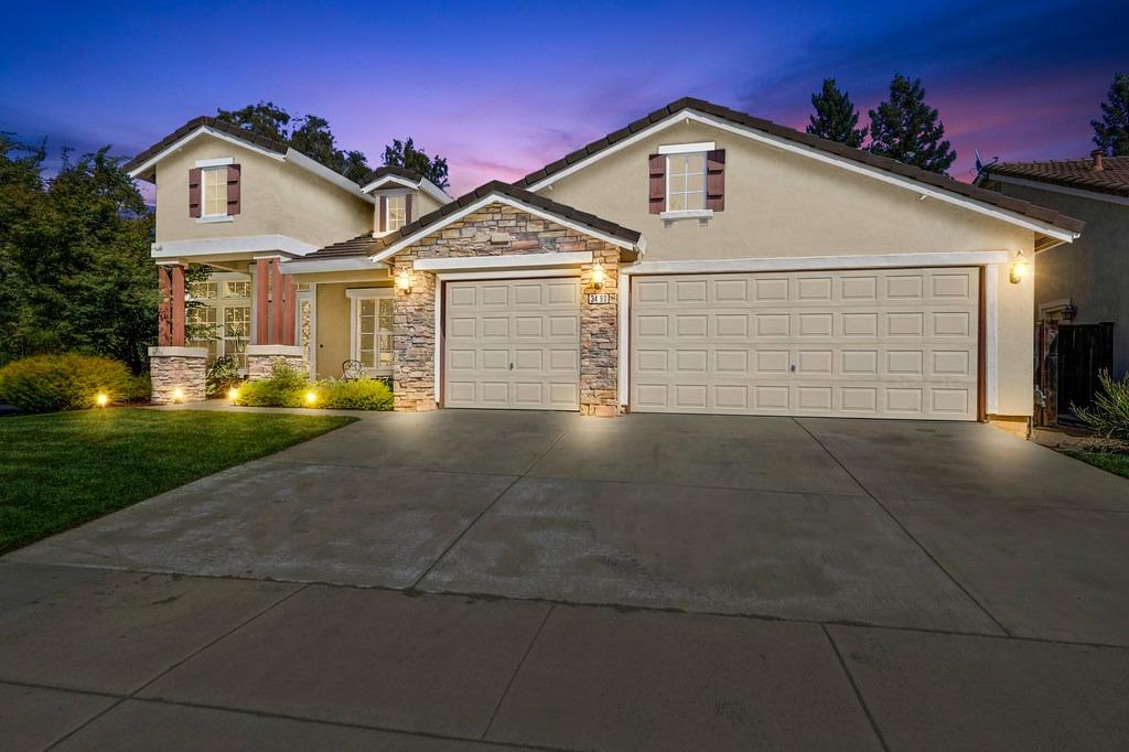 a front view of a house with a yard and garage