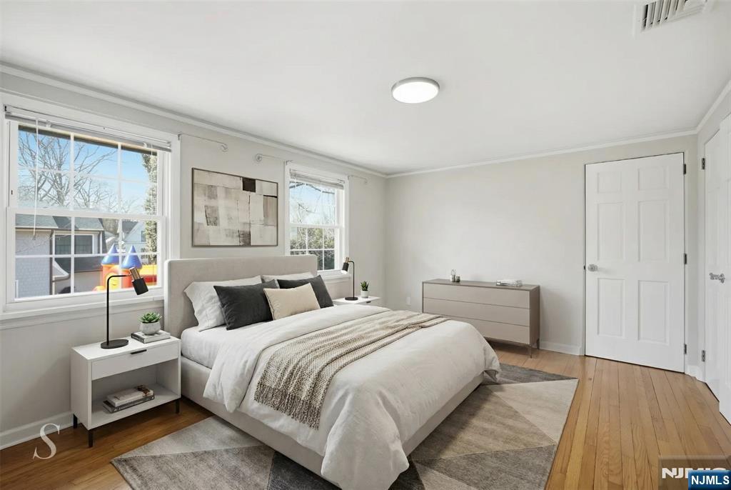 53 Forest Road Demarest, NJ 07627 - Photo 12 of 17 a bedroom with a bed and wooden floor