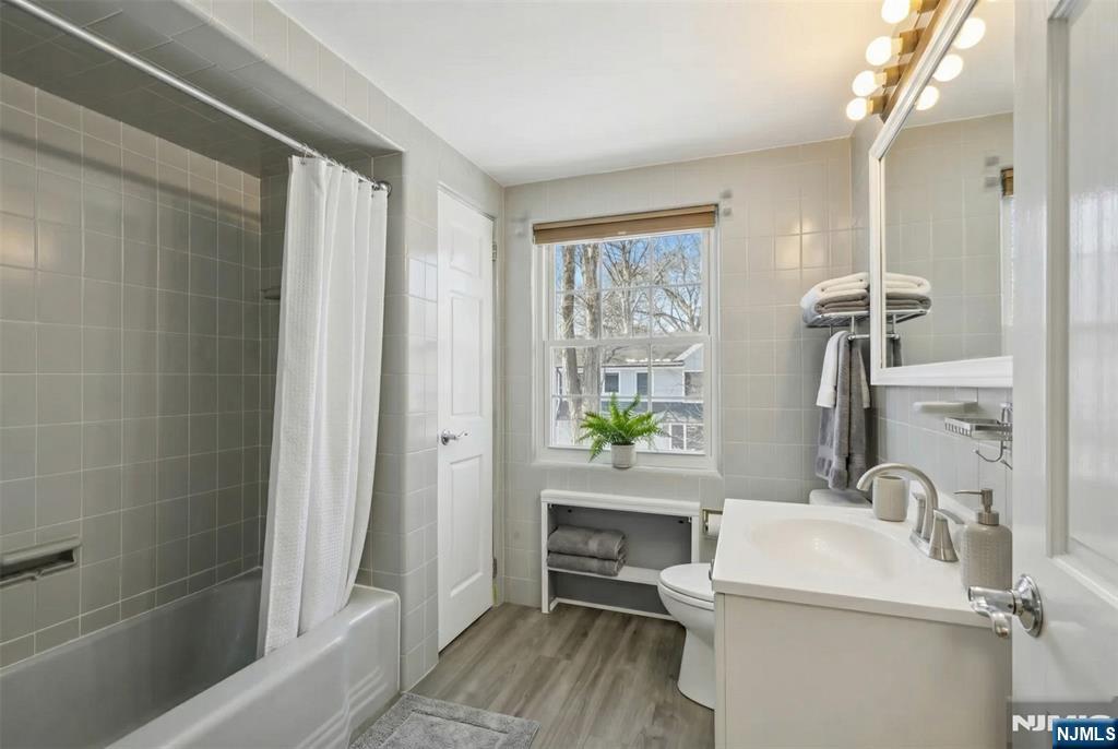 53 Forest Road Demarest, NJ 07627 - Photo 13 of 17 a bathroom with a sink a toilet and shower