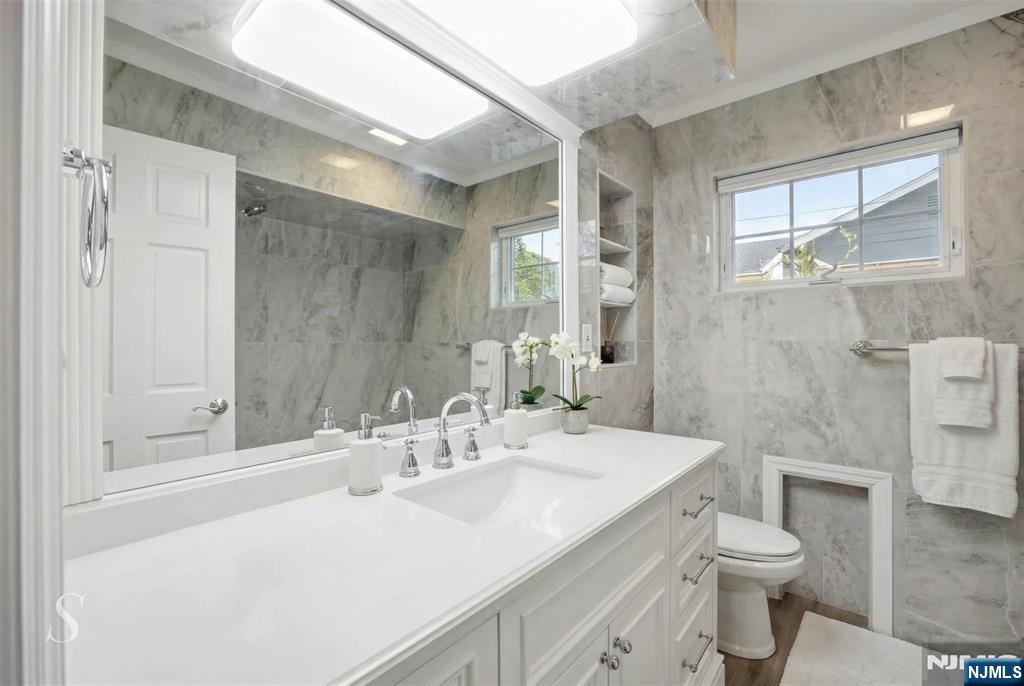 53 Forest Road Demarest, NJ 07627 - Photo 7 of 17 a bathroom with a sink toilet and shower