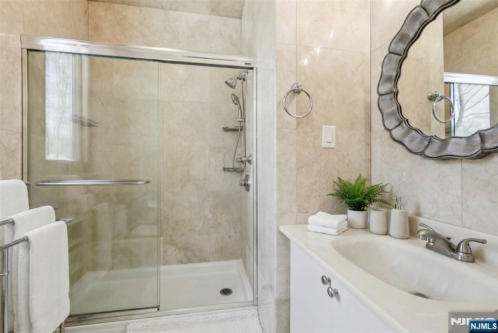 53 Forest Road Demarest, NJ 07627 - Photo 10 of 17 a bathroom with a sink and a mirror