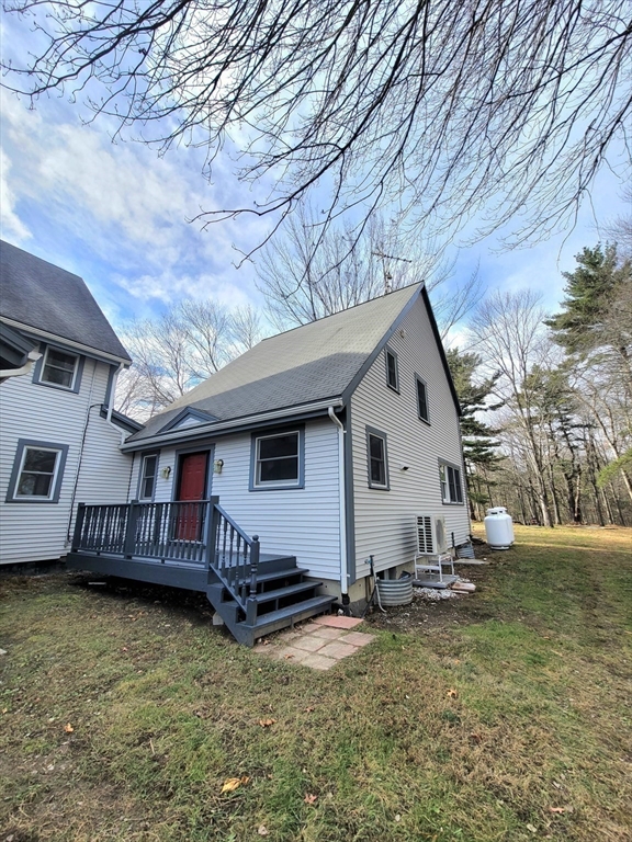 320 Old Ayer Road Groton, MA 01450 - Photo 16 of 42 a view of a house with a yard