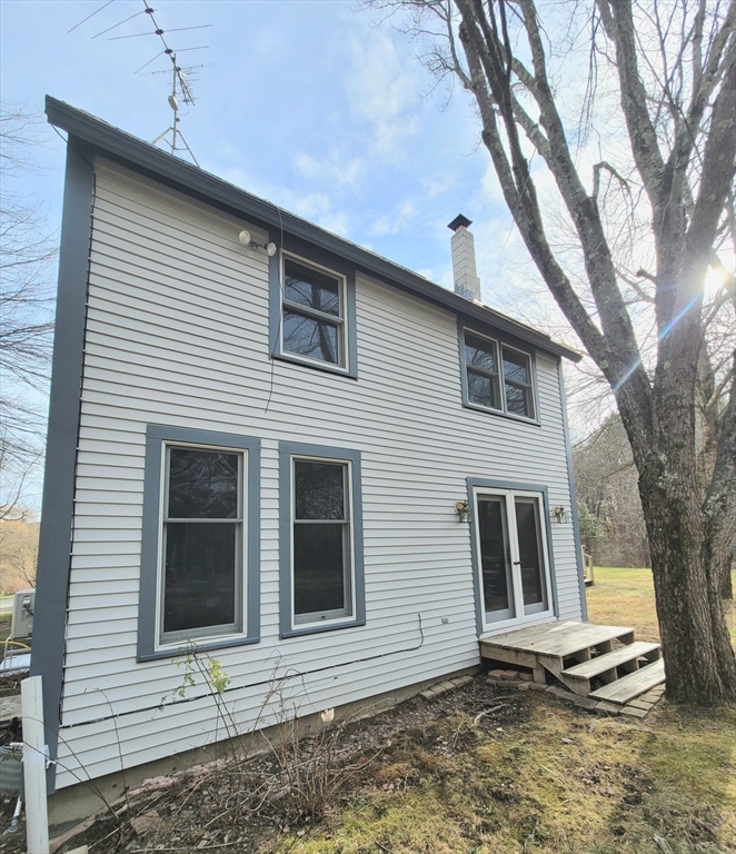 320 Old Ayer Road Groton, MA 01450 - Photo 17 of 42 a view of a house with a yard