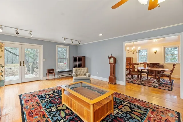 a front view of a houses with yard and large trees