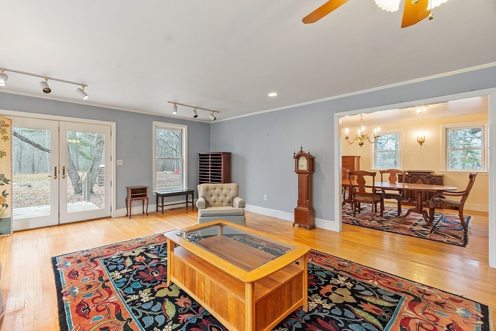 320 Old Ayer Road Groton, MA 01450 - Photo 22 of 42 a living room with furniture a rug and a floor to ceiling window