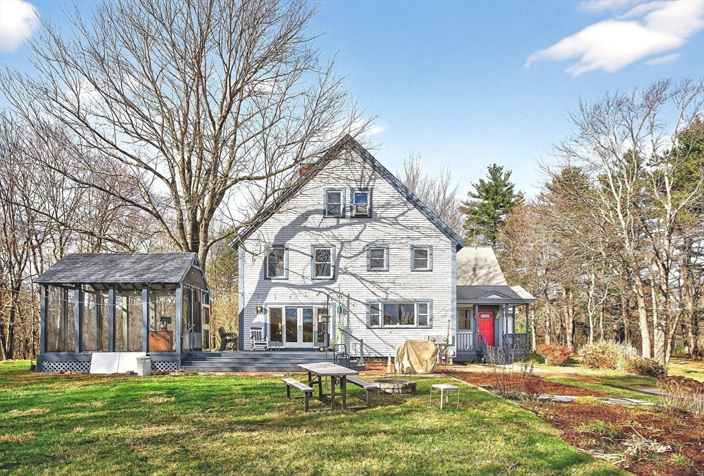 320 Old Ayer Road Groton, MA 01450 - Photo 31 of 42 a front view of residential houses with yard and trees around