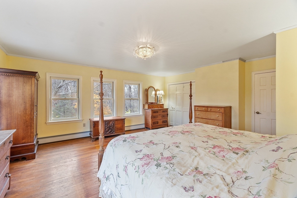 320 Old Ayer Road Groton, MA 01450 - Photo 39 of 42 a bedroom with a large bed and a large window