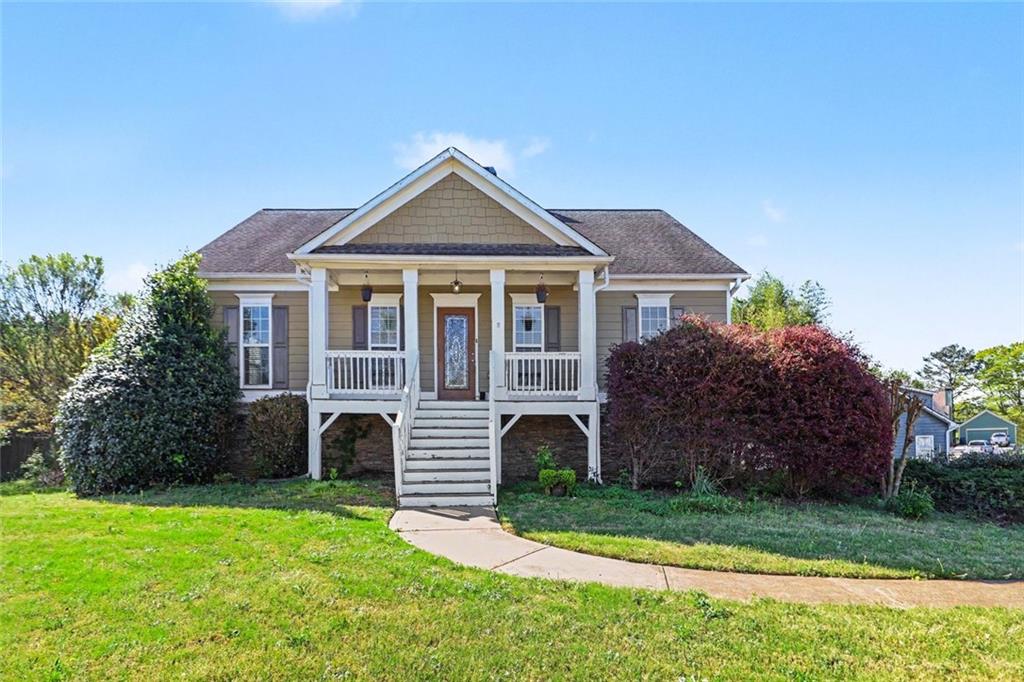 a front view of a house with a garden