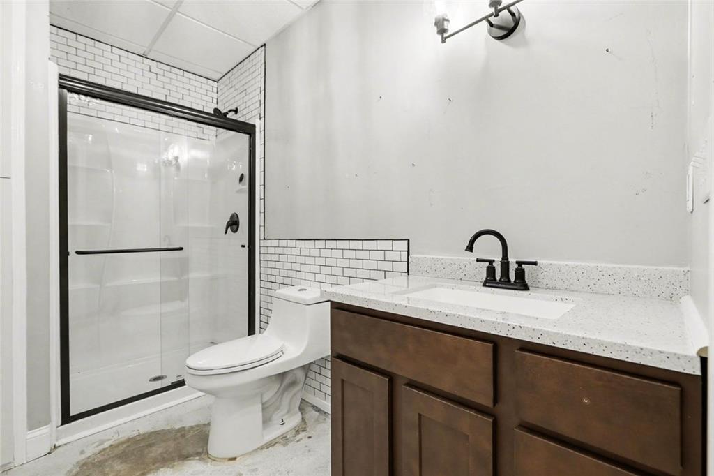 19 Safe Harbor Trail Dallas, GA 30157 - Photo 12 of 28 a bathroom with a granite countertop sink toilet and shower