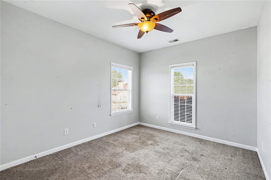 19 Safe Harbor Trail Dallas, GA 30157 - Photo 17 of 28 an empty room with windows and chandelier fan