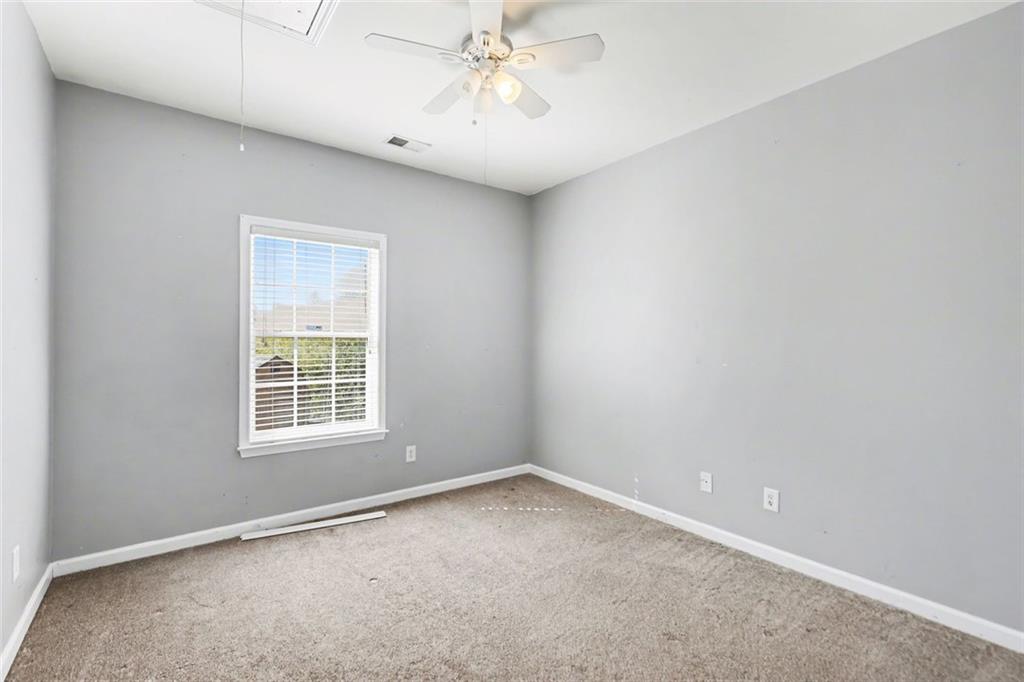 19 Safe Harbor Trail Dallas, GA 30157 - Photo 18 of 28 an empty room with a chandelier fan and windows