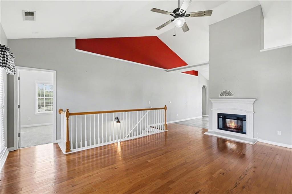 19 Safe Harbor Trail Dallas, GA 30157 - Photo 2 of 28 a view of a livingroom with wooden floor a ceiling fan and staircase