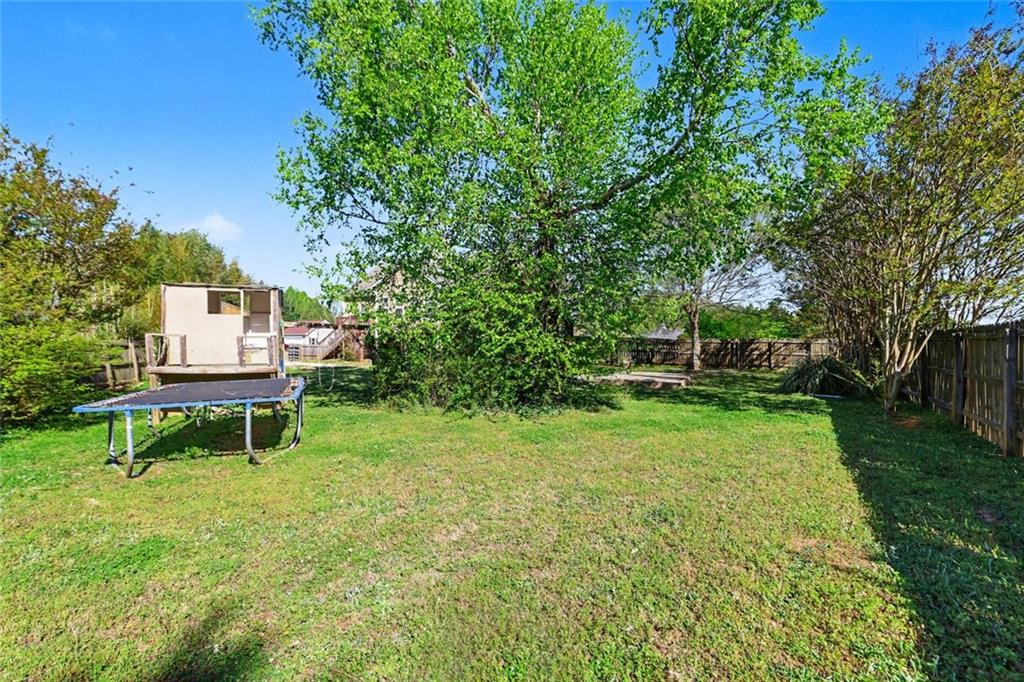 19 Safe Harbor Trail Dallas, GA 30157 - Photo 23 of 28 a view of a backyard with wooden fence and a bench