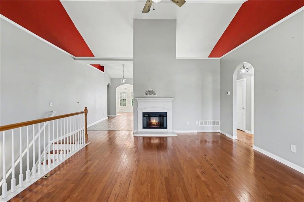 19 Safe Harbor Trail Dallas, GA 30157 - Photo 3 of 28 a view of a livingroom with wooden floor a fireplace and entryway