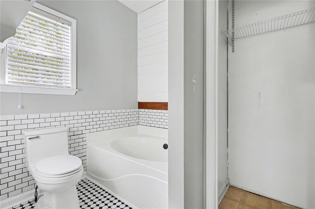 19 Safe Harbor Trail Dallas, GA 30157 - Photo 10 of 28 a bathroom with a toilet and a bathtub