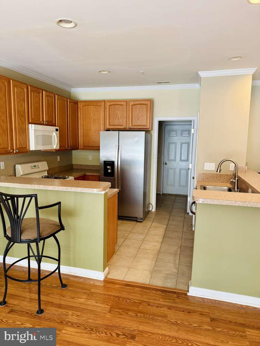 629 Ruxton Road, Unit 74 Solomons, MD 20629 - Photo 4 of 24 a kitchen with stainless steel appliances granite countertop a refrigerator sink and cabinets