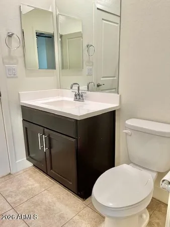 a bathroom with a sink toilet and mirror