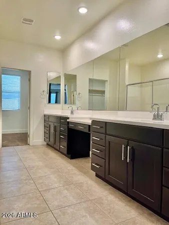 a bathroom with a sink vanity and a mirror