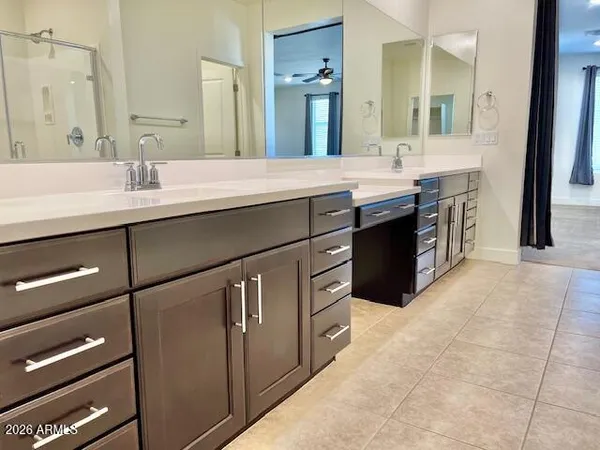 a spacious bathroom with a double vanity sink a and a mirror