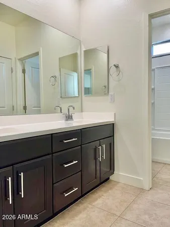 a bathroom with a double vanity sink and a mirror