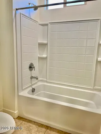 a bathroom with bathtub and shower