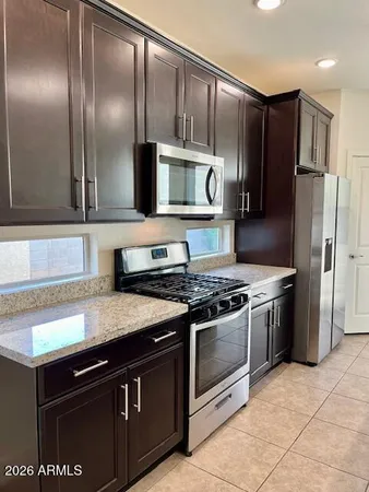 a kitchen with granite countertop stainless steel appliances and wooden cabinets