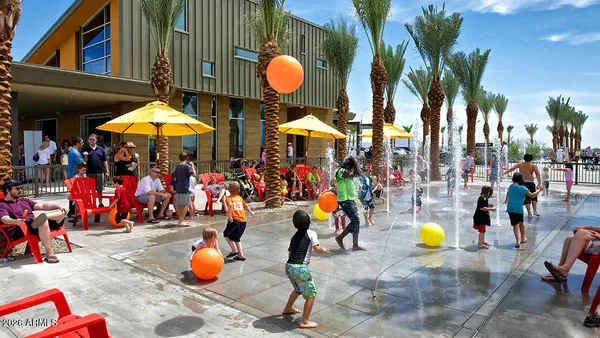 a group of people sitting under an umbrella