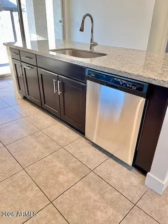 a kitchen with granite countertop a sink and a stove