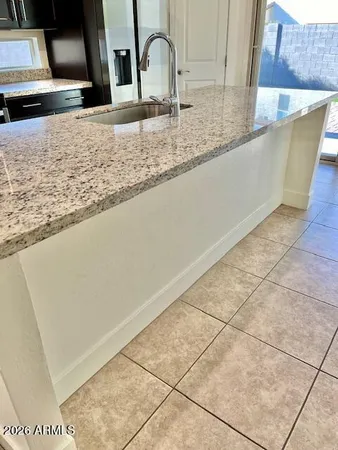 a kitchen with granite countertop a sink and a stove