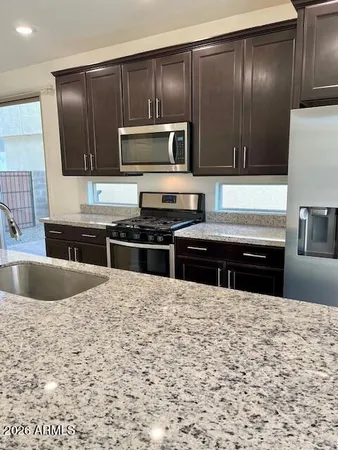 a kitchen with stainless steel appliances wooden cabinets and a sink