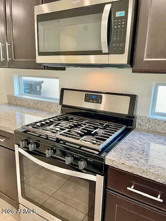 a stove top oven sitting inside of a kitchen