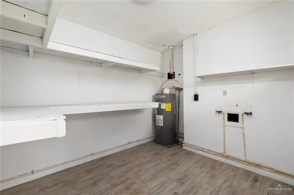 a view of storage and utility room with closet