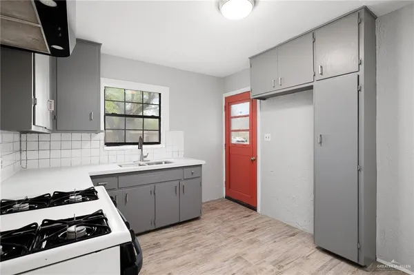 a kitchen with stainless steel appliances a sink stove and refrigerator