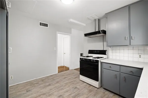 a kitchen with a stove and a refrigerator