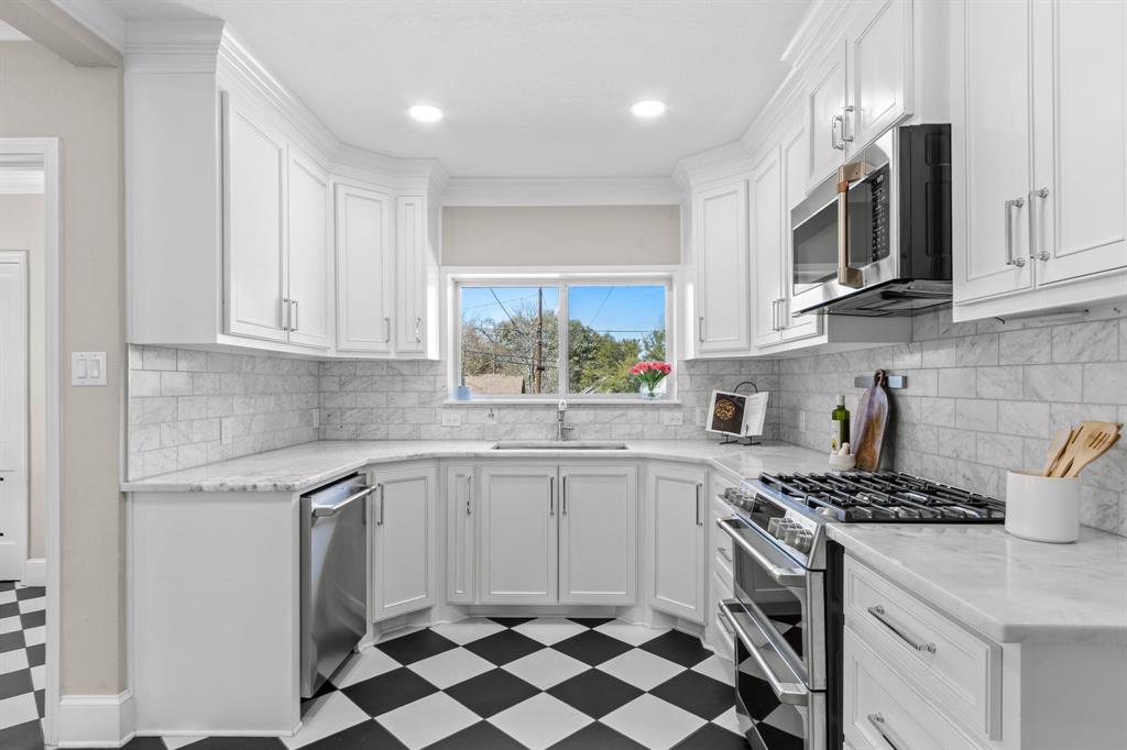 2815 Cumberland Avenue Waco, TX 76708 - Photo 12 of 40 a kitchen with stainless steel appliances a stove sink microwave and cabinets