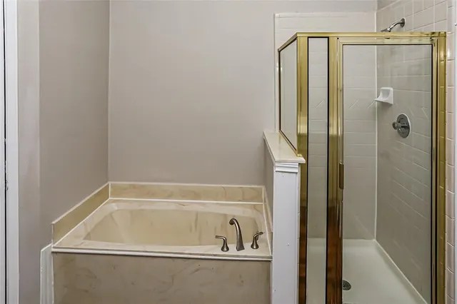 a bathroom with a shower and a sink