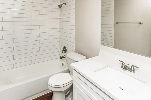a bathroom with a sink a toilet and a bathtub