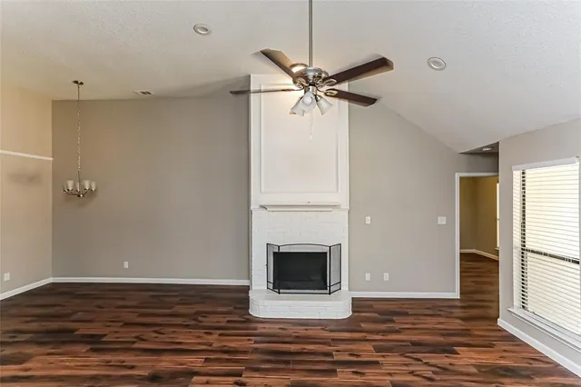 a view of a livingroom with a fireplace and a window