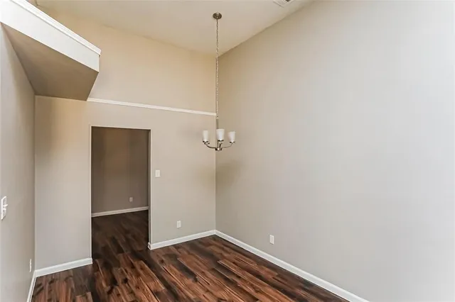 a view of a room with wooden floor
