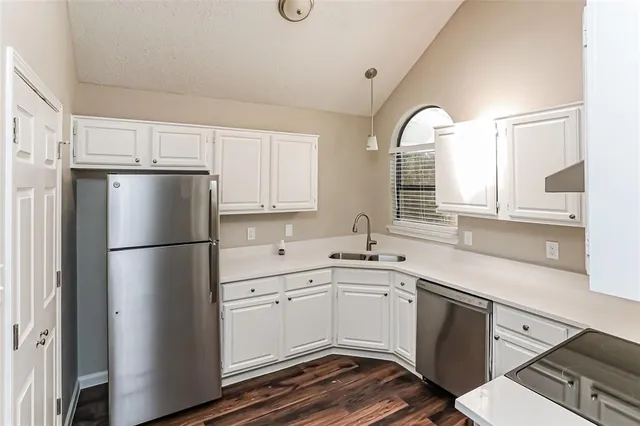 a kitchen with a white cabinets and white appliances