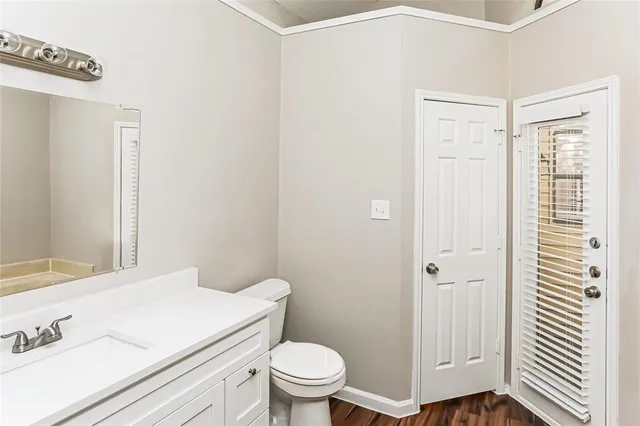 a white toilet sitting next to a bathroom sink