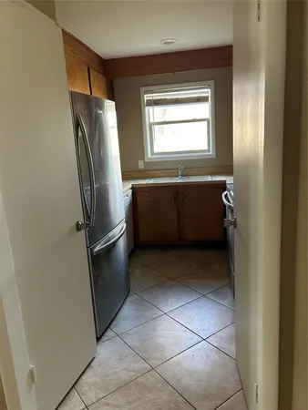 a room with a wooden cabinets and refrigerator
