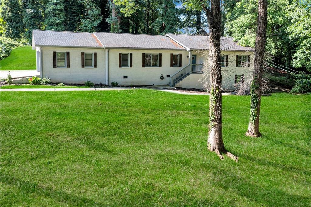 2418 Bolling Brook Drive Southwest Atlanta, GA 30311 - Photo 1 of 37 a front view of house with yard and green space