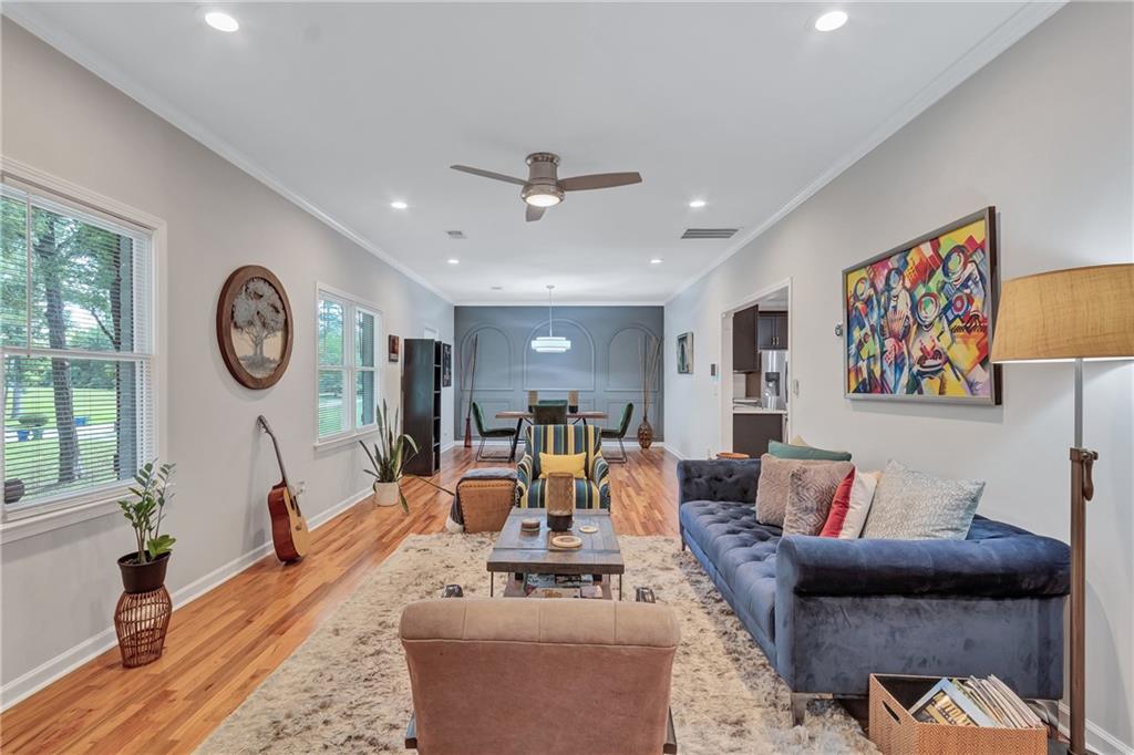 2418 Bolling Brook Drive Southwest Atlanta, GA 30311 - Photo 11 of 37 a living room with furniture a clock on wall and a large window