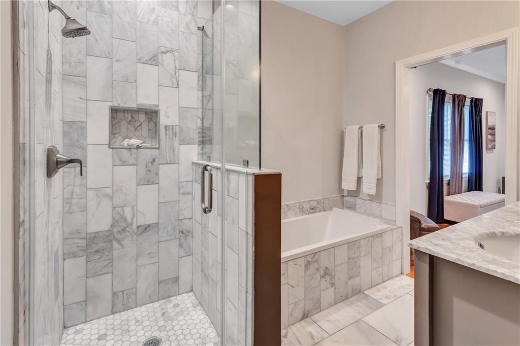 2418 Bolling Brook Drive Southwest Atlanta, GA 30311 - Photo 20 of 37 a bathroom with a granite countertop shower a sink and a mirror