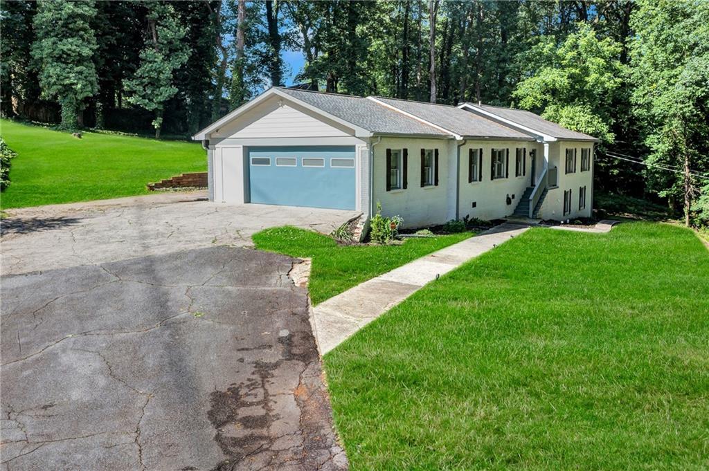 2418 Bolling Brook Drive Southwest Atlanta, GA 30311 - Photo 2 of 37 a front view of a house with a yard and green space