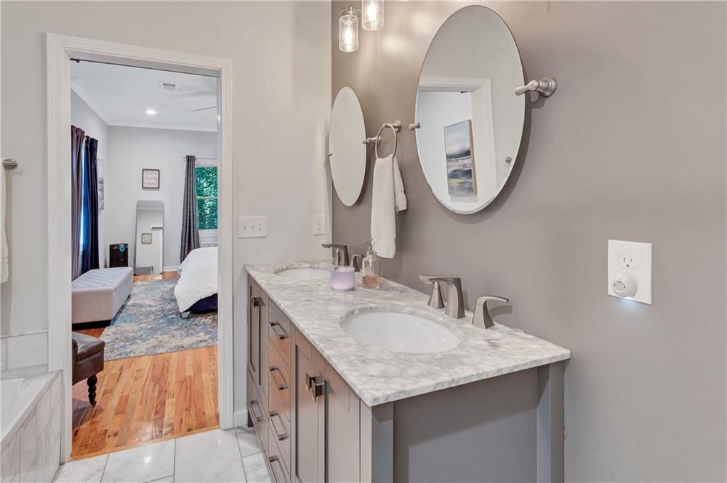 2418 Bolling Brook Drive Southwest Atlanta, GA 30311 - Photo 21 of 37 a en suite bathroom with a granite countertop sink mirror and vanity